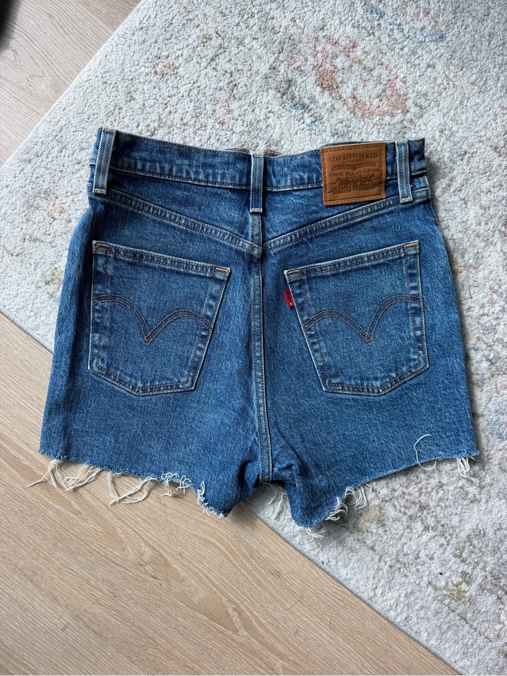 Levi's 501 Denim Cutoff Shorts in Medium Blue with Frayed Hem
